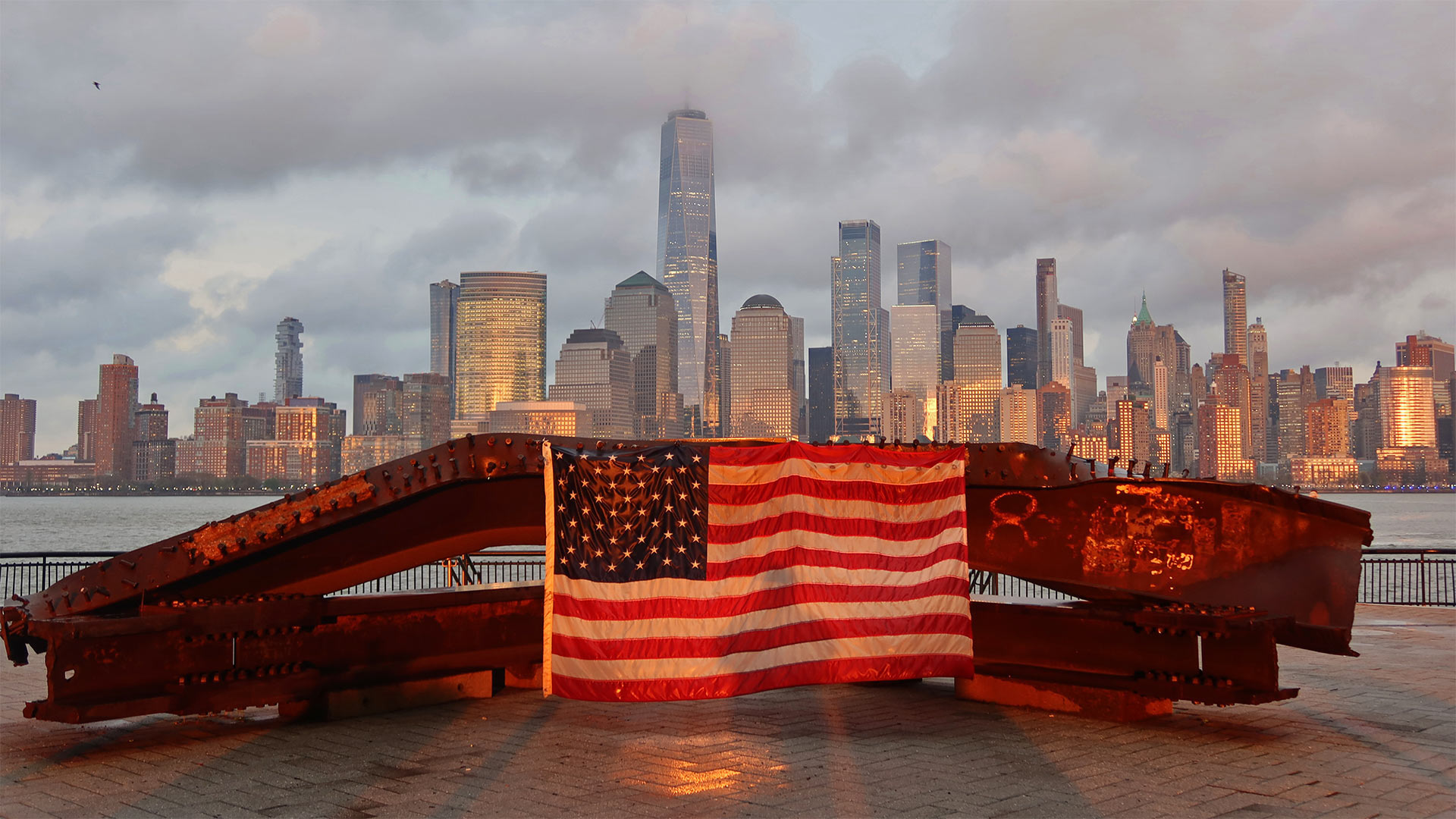 US flag on part of a 9/11 memorial overlooking the New York skyline from Exchange Place, Jersey City, New Jersey (© Gary Hershorn/Getty Images)(Bing United States)