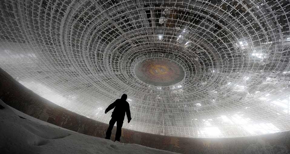 A man walks inside the crumbling skeleton of the House of the Bulgarian Communist Party on Mount Buzludzha, Bulgaria (© Dimitar Dilkoff/Getty Images) &copy; (Bing Canada)