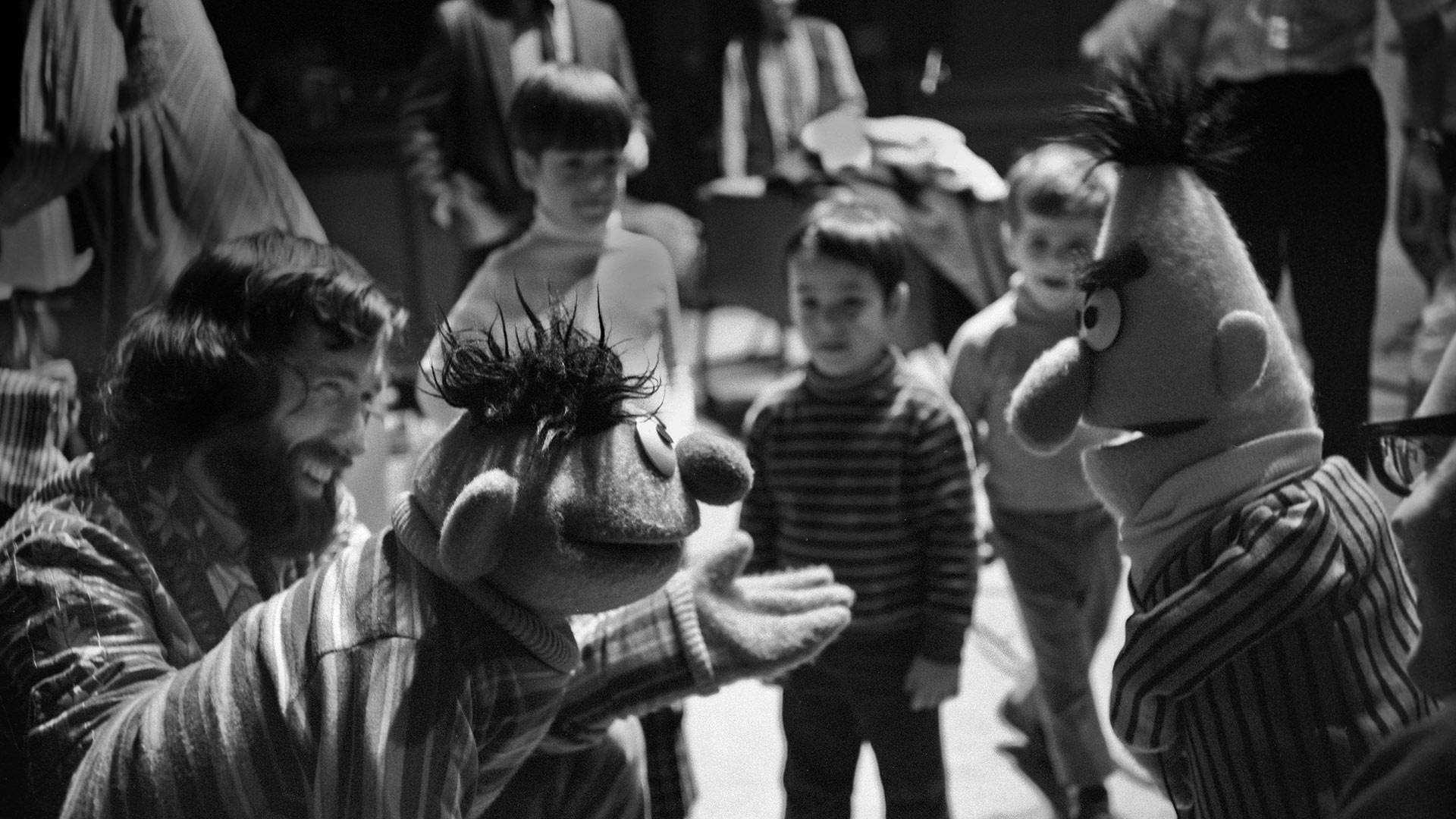 Jim Henson, along with Ernie and Bert, rehearses for an episode of 