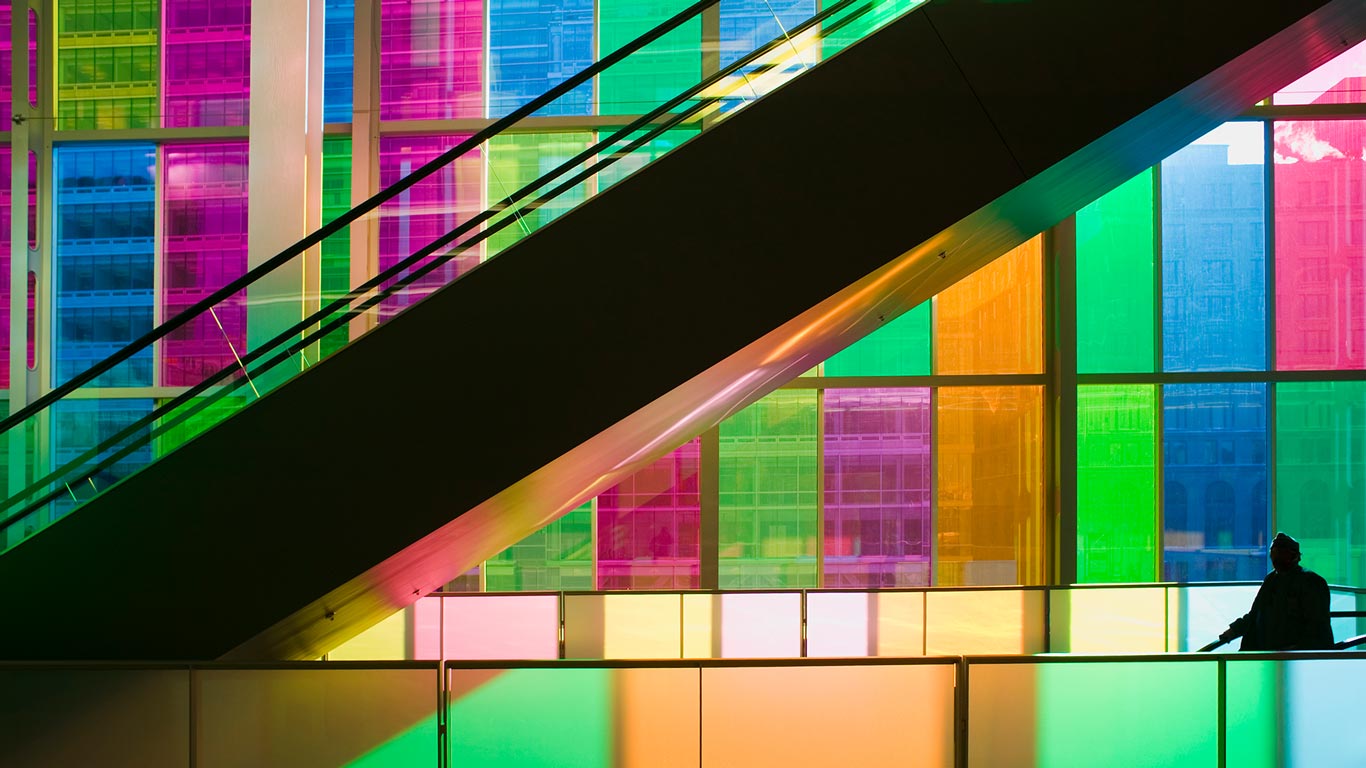 Silhouetted man standing in front of multicolored glass windows of Montreals Palais des Congres Montreal, Quebec, Canada (© Mark Tomalty/Axiom)(Bing Canada)
