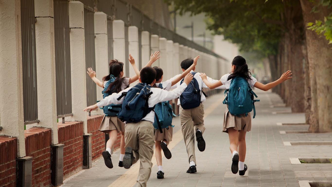 上学路上，身穿校服的学生的背影 (© Blue Jean Images/Alamy)(Bing China)