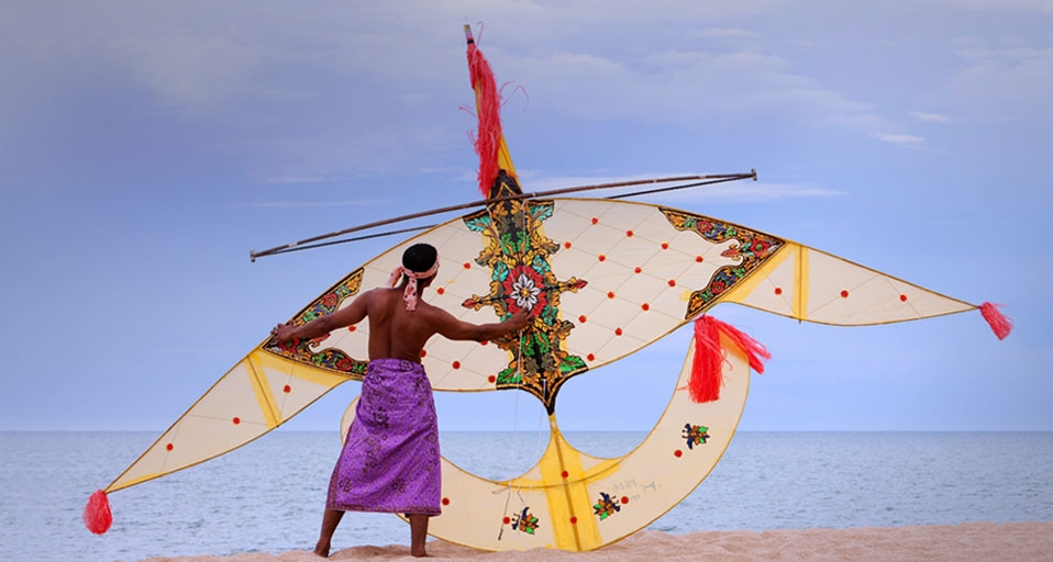 A Malaysian man holds a traditional handmade kite -- Hugh Sitton/Corbis &copy; (Bing Canada)