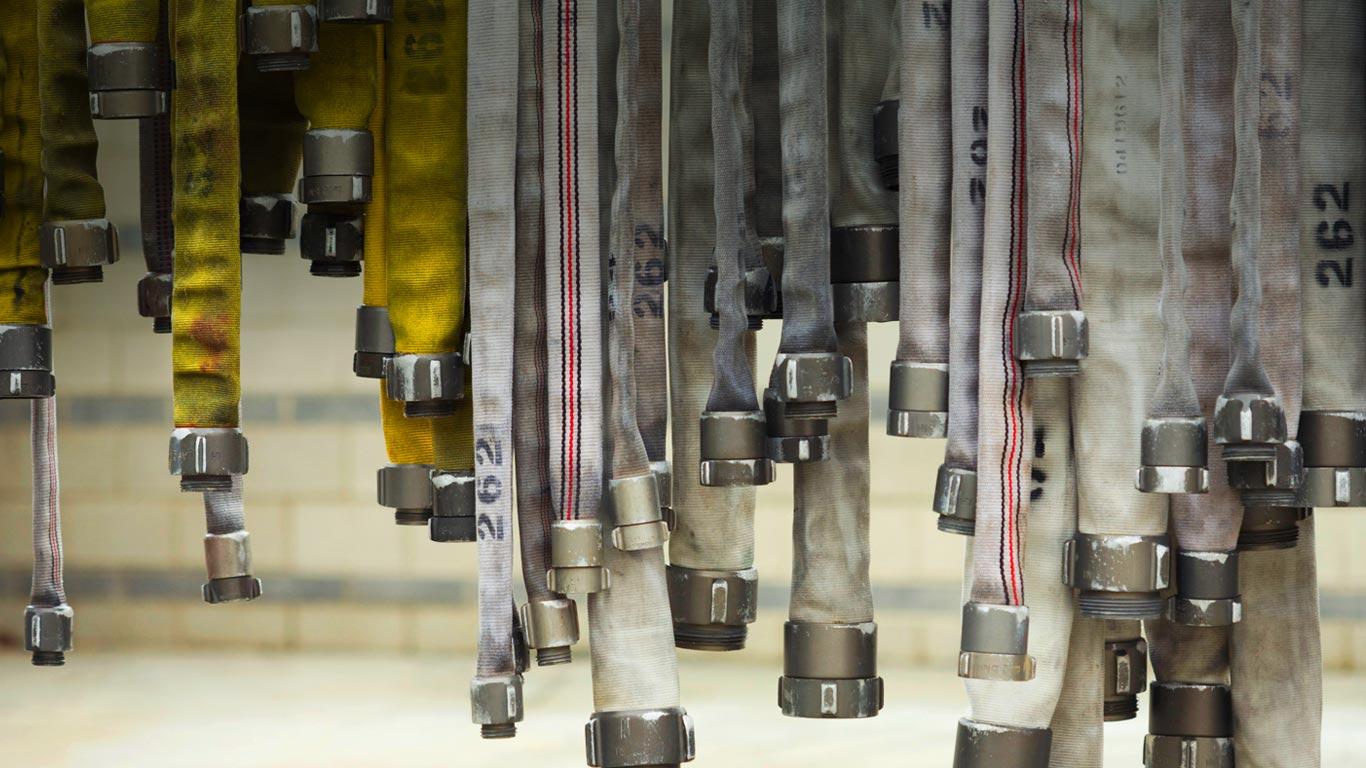 Fire hoses hanging to dry (© PBNJ Productions/Corbis)(Bing United States)