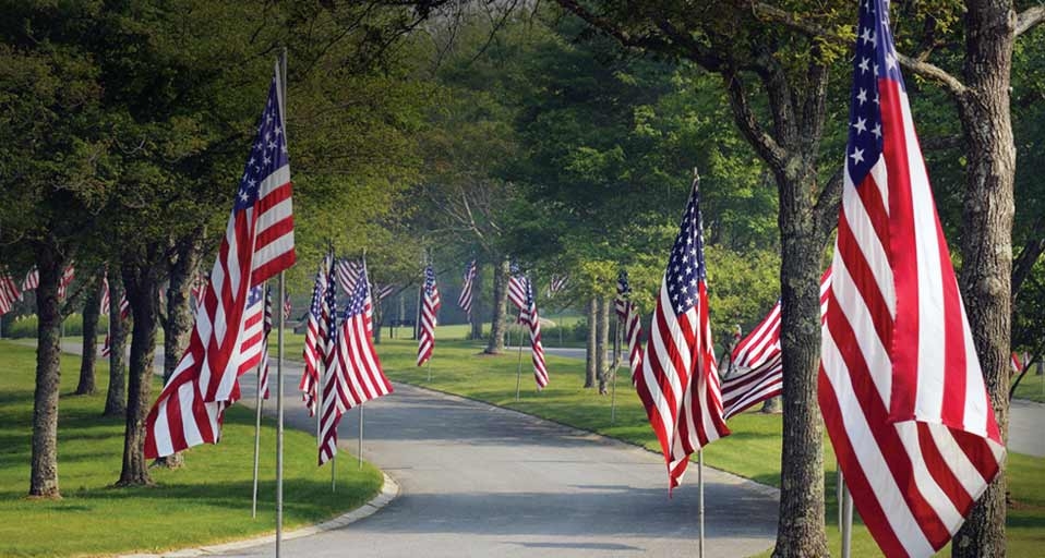 Flags line the entrance of the Massachusetts National Cemetery in Bourne, Cape Cod, Massachusetts -- Michael Neelon/age fotostock &copy; (Bing United States)