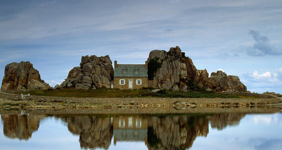House between rocks is reflected in Brittany, France -- Axiom Photographic/Masterfile &copy; (Bing Canada)