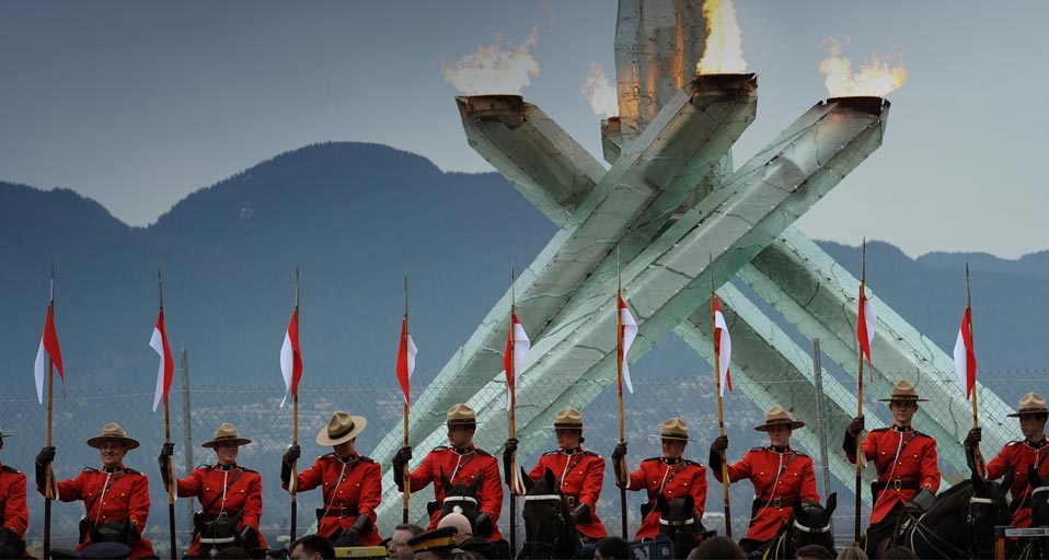 Canadian mounties parade with their horses in front of the Olympic flame in Vancouver on February 23, 2010 on the sidelines of the Vancouver Winter Olympics. (VINCENZO PINTO/AFP/Getty Images) &copy; (Bing Canada)