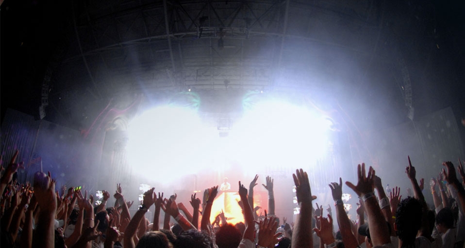 Party goers dance with their arms raised during a dance rave party music festival in Melbourne -- Julian Smith/Corbis &copy; (Bing Australia)